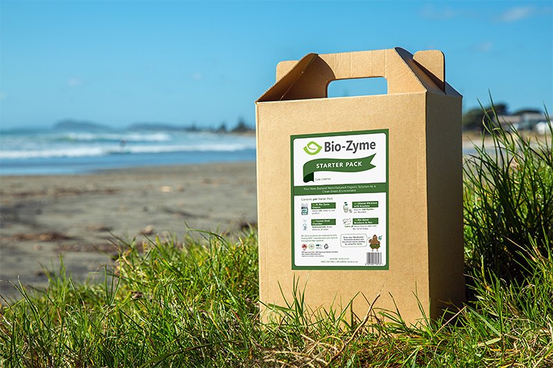 Bio-Zyme Starter Pack box standing on the grass in the beach showing a blue sky in the background